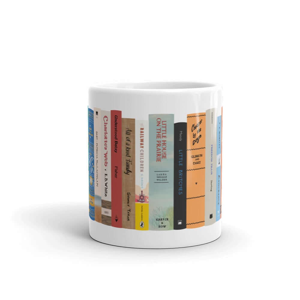 The Peaceful Preschool Mothering By The Book mug in white with a painting of a bookshelf with books on it.