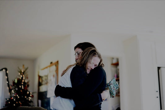 The Power of Small Habits in Your Homeschool: two people embracing in a warm indoor setting.