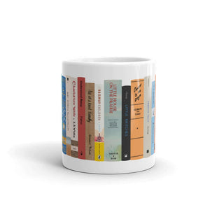 The Peaceful Preschool Mothering By The Book mug in white with a painting of a bookshelf with books on it.